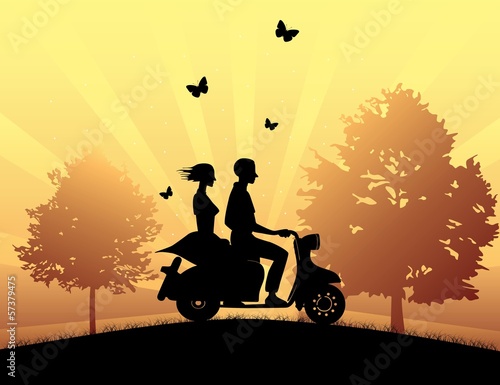 Girl and boy riding a scooter at the park