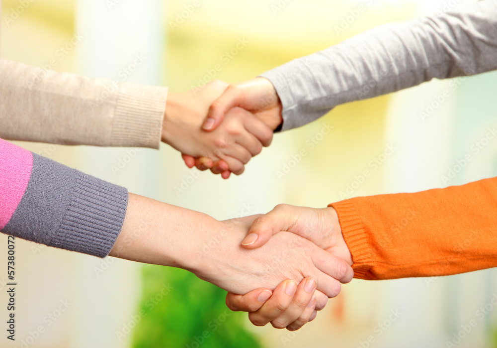 Handshakes on bright background Handshakes on bright background
