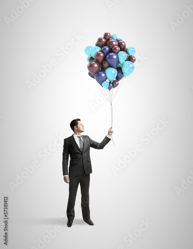 businessman holding baloons © peshkova
