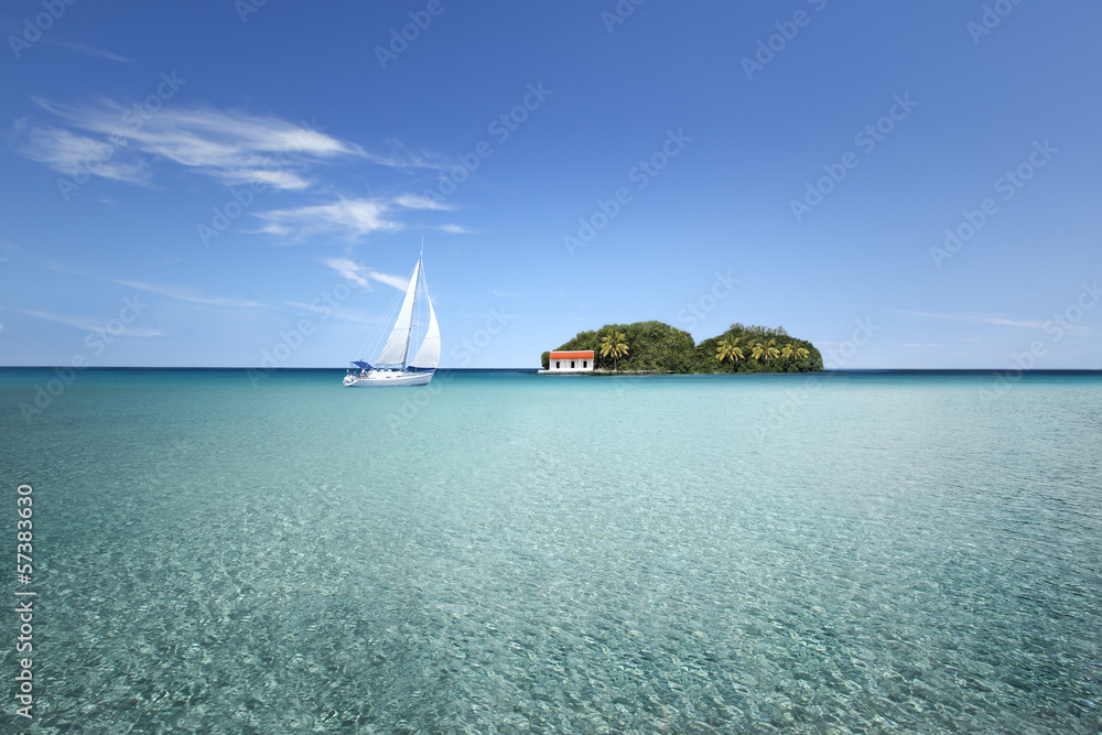 Obraz premium île au milieu d'un lagon avec voilier