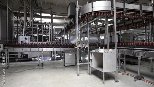 The food industry. Plastic beer bottles moving on conveyor
