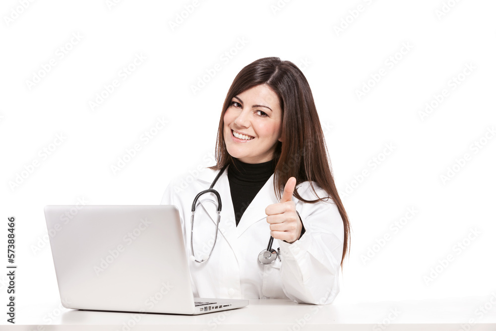 Female doctor sitting at her desk and smiles towards the camera Female doctor sitting at her desk and smiles towards the camera
