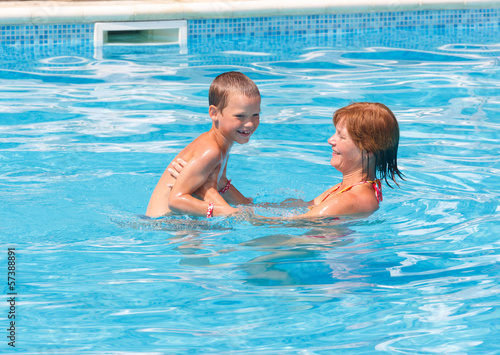Mother with her son in the pool.