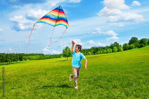 Happy boy run with kite