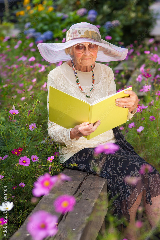 Fashionable old lady reading in her 