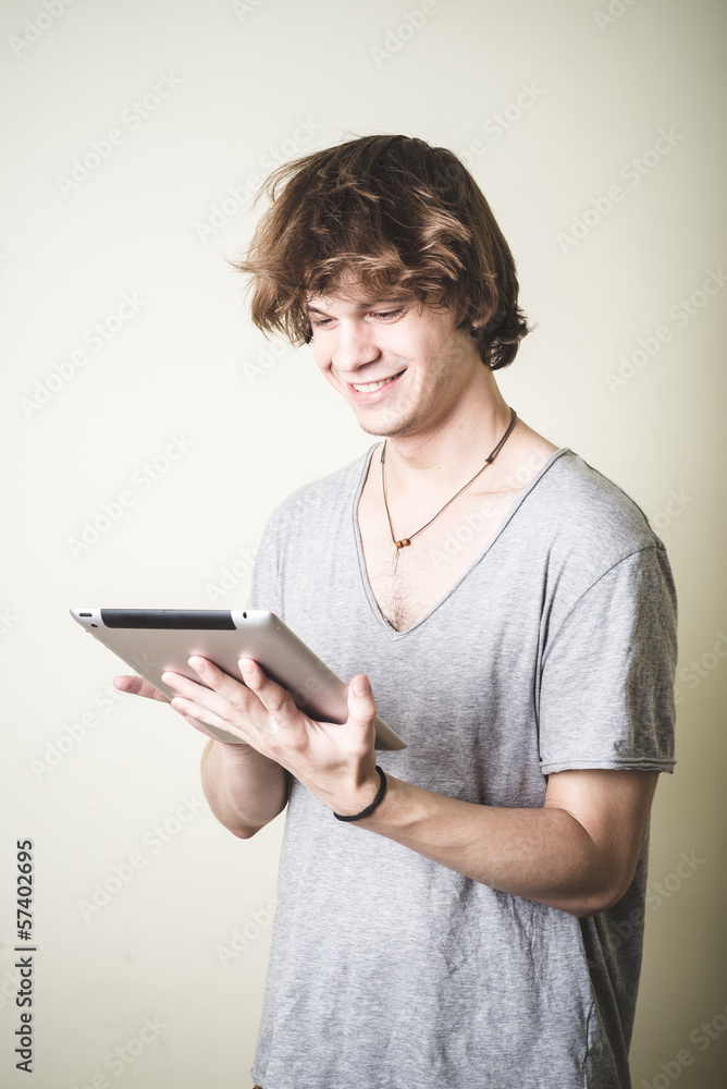 stylish young blonde hipster man using tablet stylish young blonde hipster man using tablet
