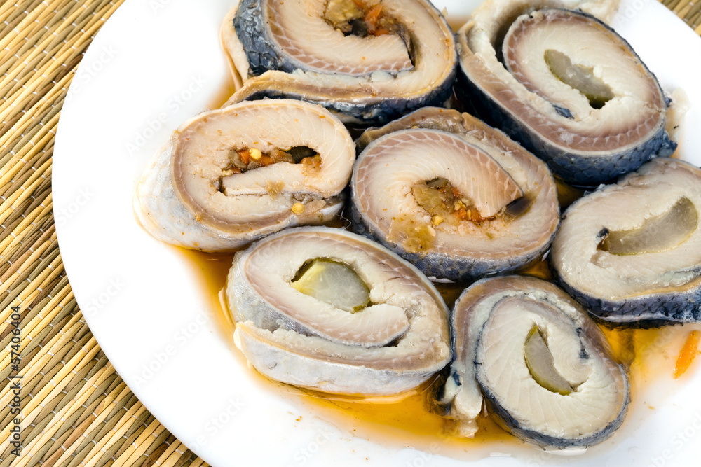 Rolls from a herring on a plate