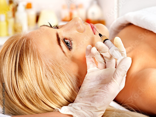 Doctor woman giving botox injections. photo