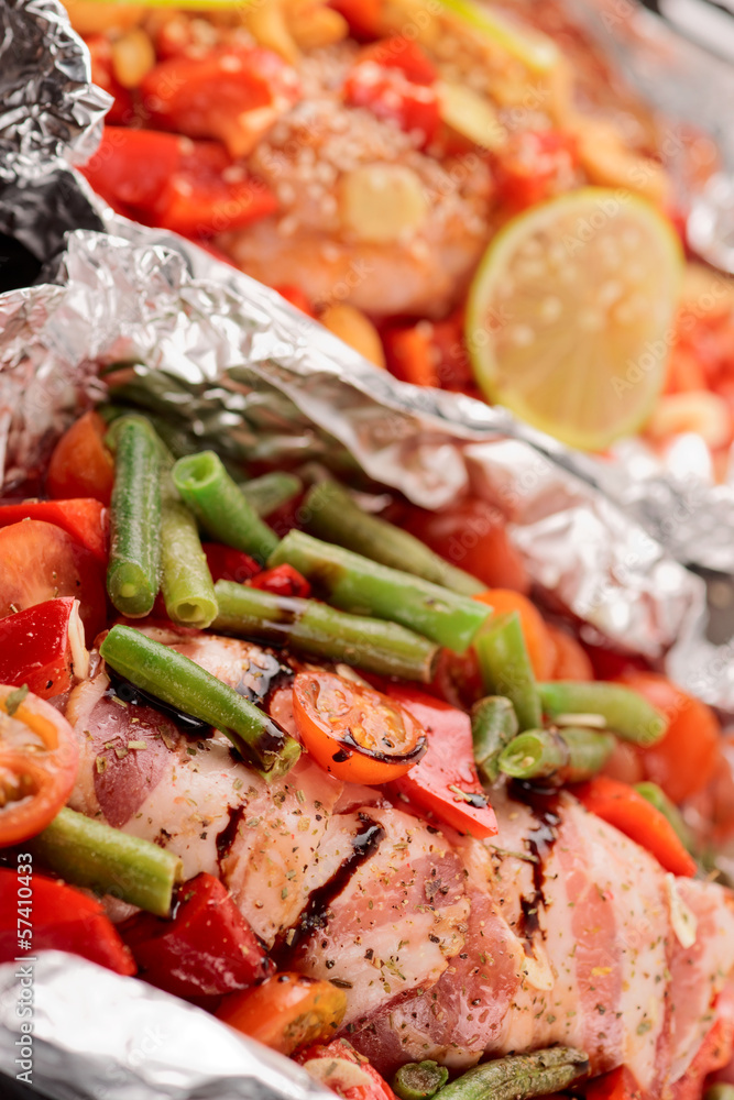 Two uncooked dishes in foil