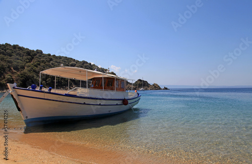 Fototapeta Naklejka Na Ścianę i Meble -  Small traditional ship on a sandy beach, Greece