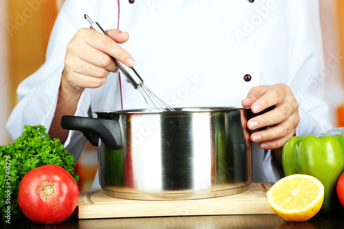 Cook hands and pan at workplace