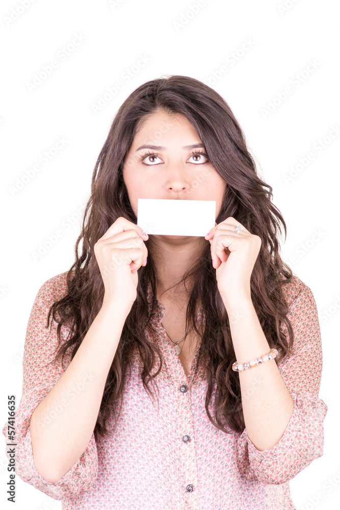 Young woman holding a blank business card in front of her mouth. Young woman holding a blank business card in front of her mouth.