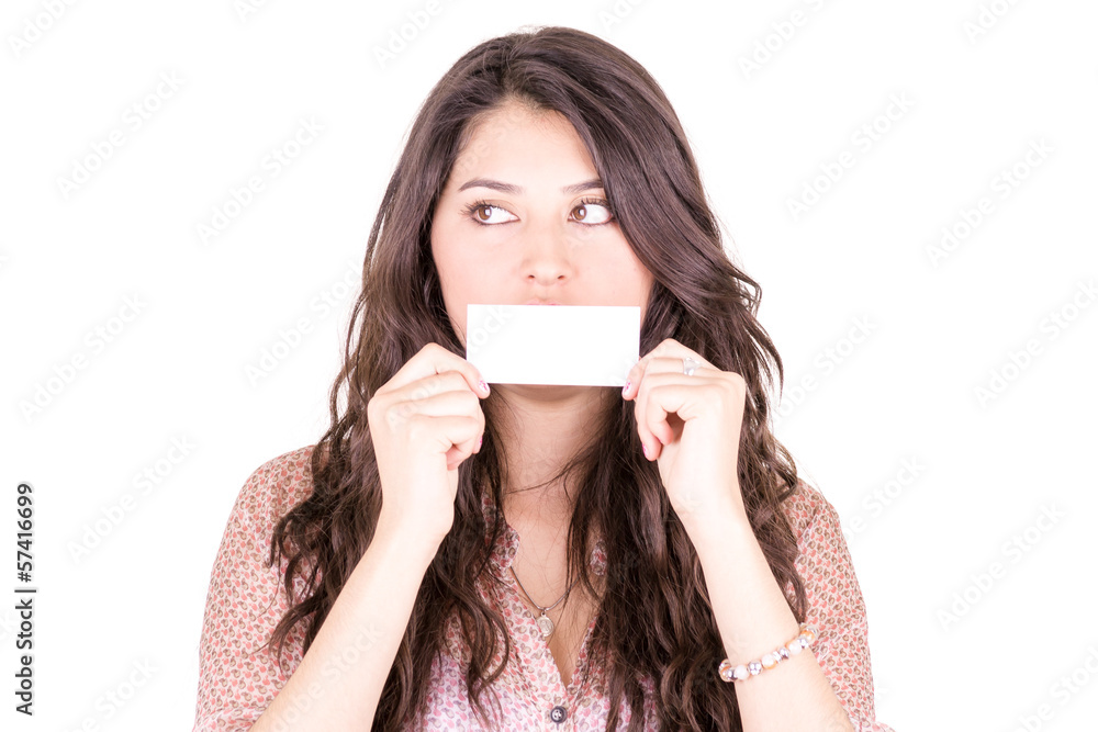 Young woman holding a blank business card in front of her mouth. Young woman holding a blank business card in front of her mouth.