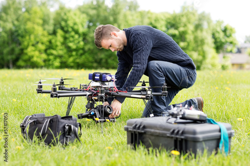 Engineer Setting Camera On UAV Helicopter photo