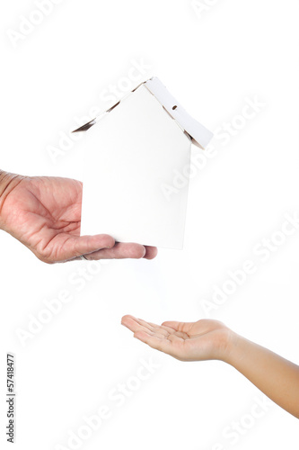 Old woman's hand giving paper home to child isolated