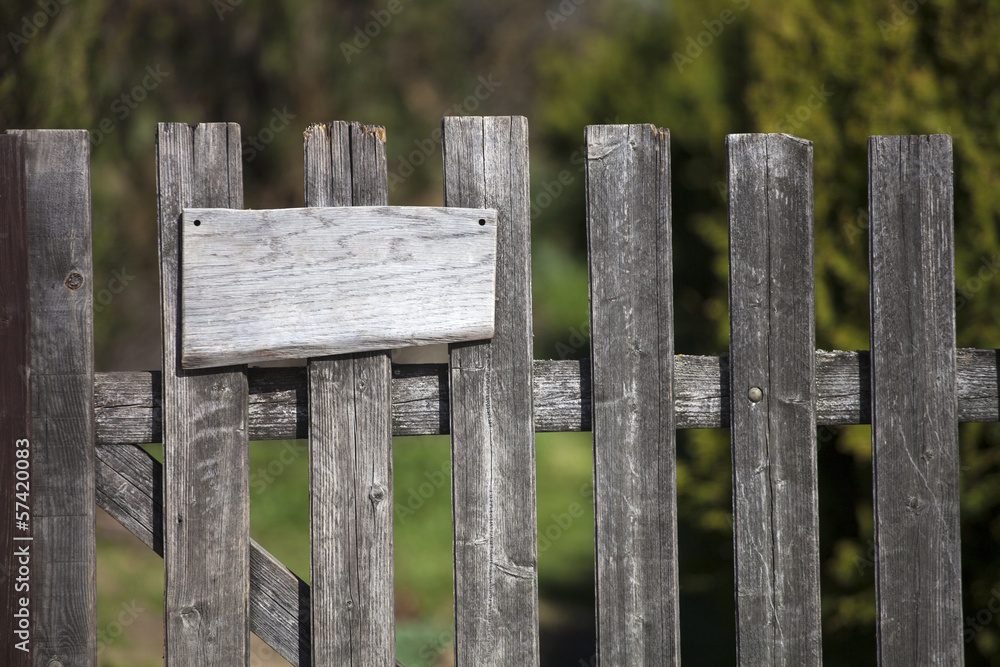 Wooden fence with empty sign board