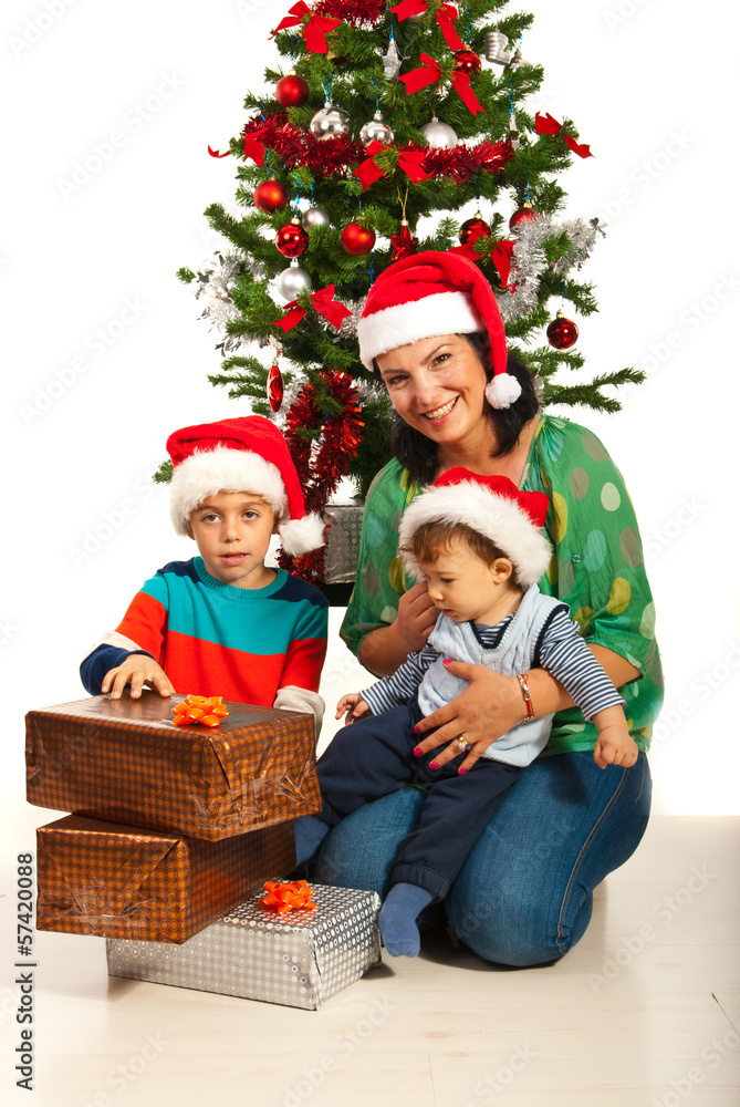Mother with kids near Christas tree Mother with kids near Christas tree