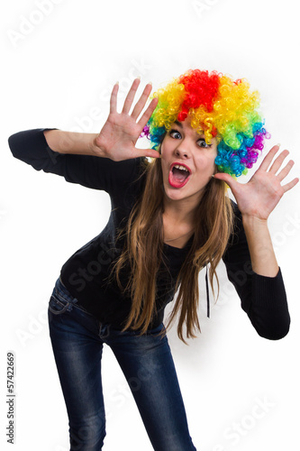 On the head of the cheerful girl multi-colored wig