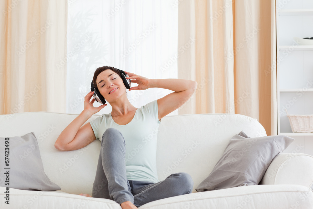 Delighted brunette enjoying some music Delighted brunette enjoying some music