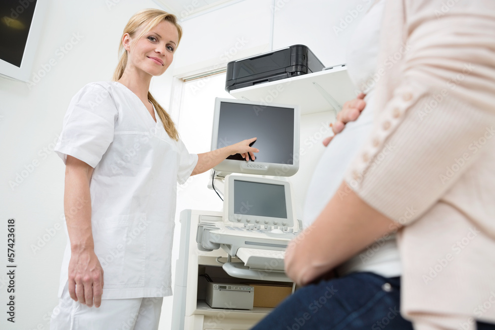 Gynecologist Showing Ultrasound Scan To Pregnant Woman Gynecologist Showing Ultrasound Scan To Pregnant Woman