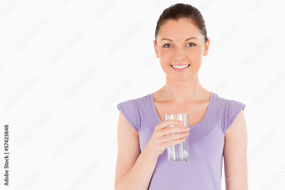 Beautiful woman holding a glass of water while standing Beautiful woman holding a glass of water while standing