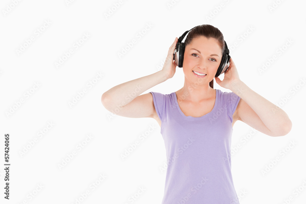 Charming woman posing with headphones while standing Charming woman posing with headphones while standing