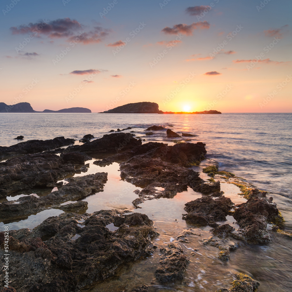 Stunning landscapedawn sunrise with rocky coastline and long exp