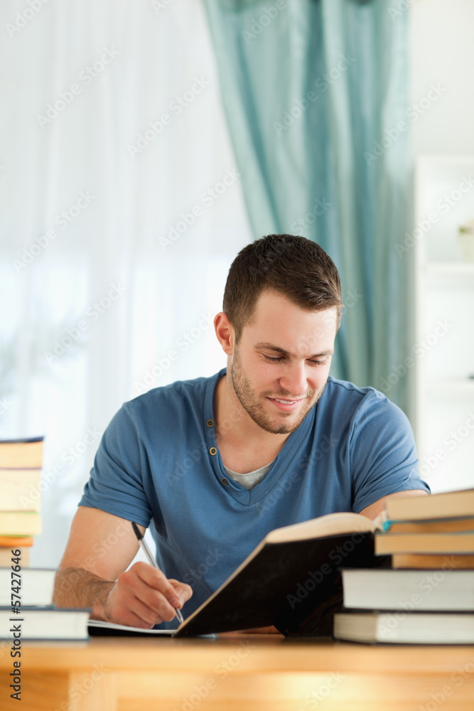 Smiling student reviewing his subject material Smiling student reviewing his subject material