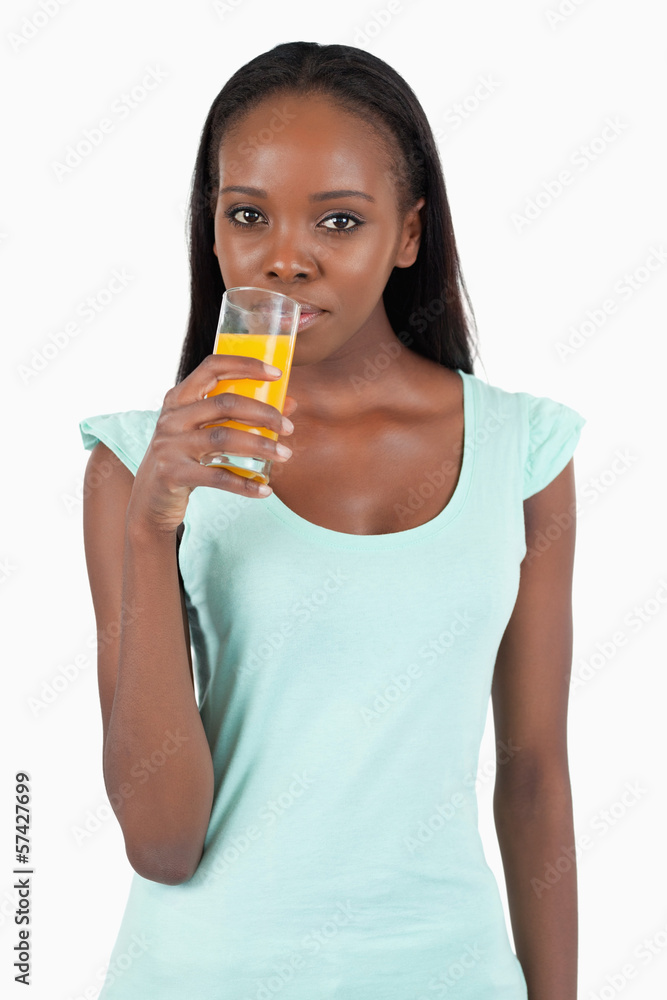 Young woman drinking some orange juice Young woman drinking some orange juice