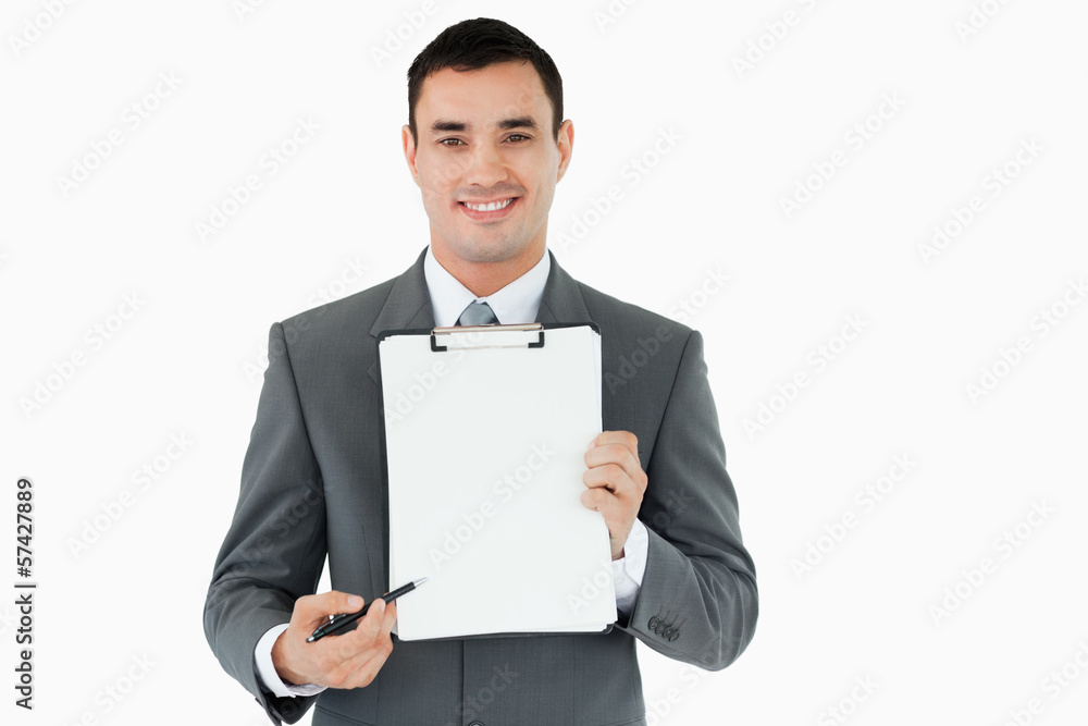 Businessman pointing with pen on clipboard Businessman pointing with pen on clipboard
