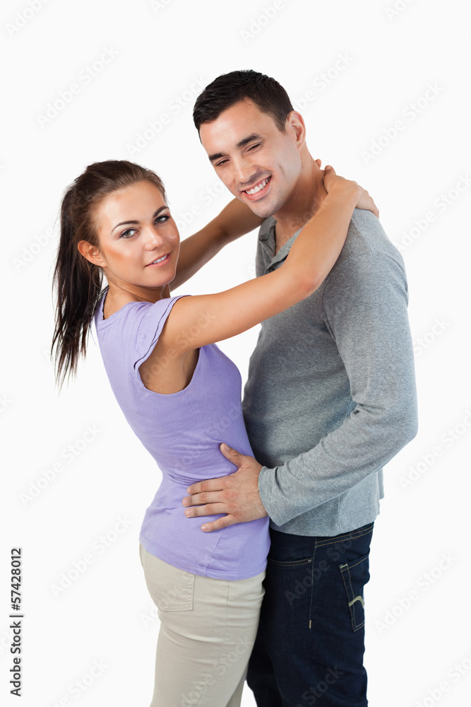 Side view of young couple hugging Side view of young couple hugging
