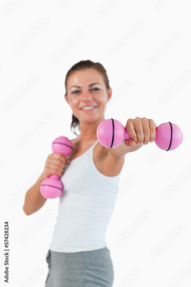 Portrait of a happy woman working out with dumbbells Portrait of a happy woman working out with dumbbells