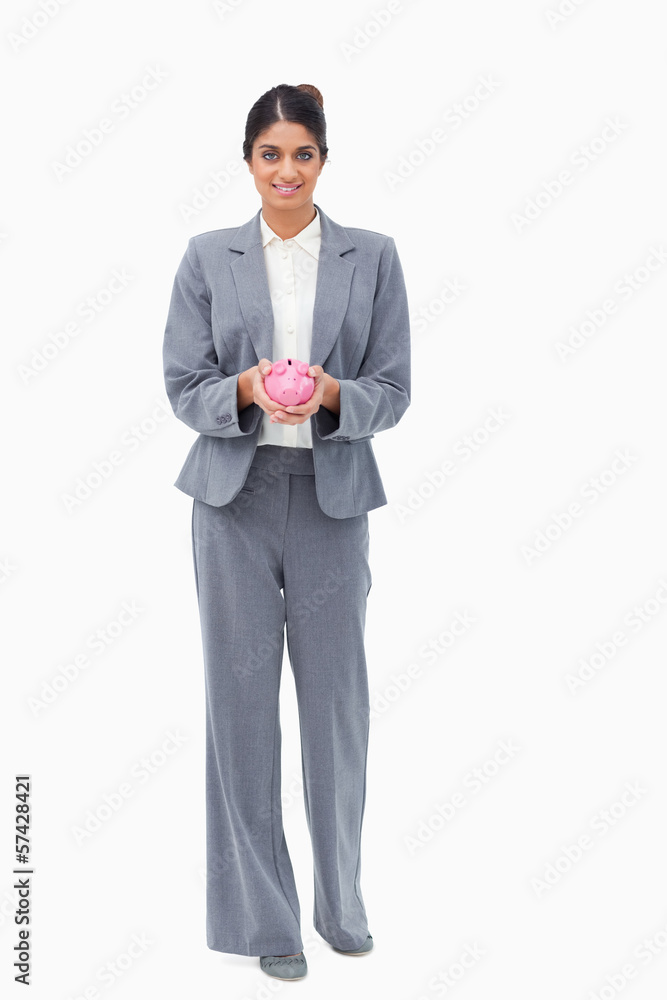 Smiling bank employee with piggy bank in her hands Smiling bank employee with piggy bank in her hands