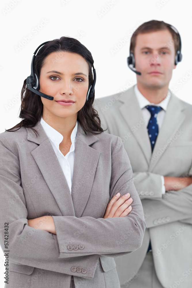 Call center agents with headsets and arms folded Call center agents with headsets and arms folded