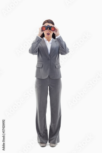 Surprised businesswoman looking through binoculars © WavebreakMediaMicro