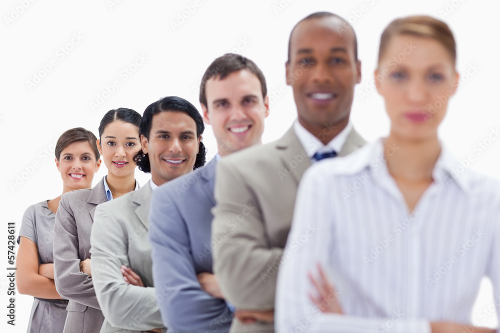 Close-up of happy workmates dressed in suits crossing their arms Close-up of happy workmates dressed in suits crossing their arms
