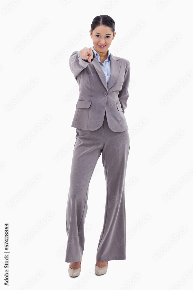 Portrait of a young brunette businesswoman pointing at the viewe Portrait of a young brunette businesswoman pointing at the viewe