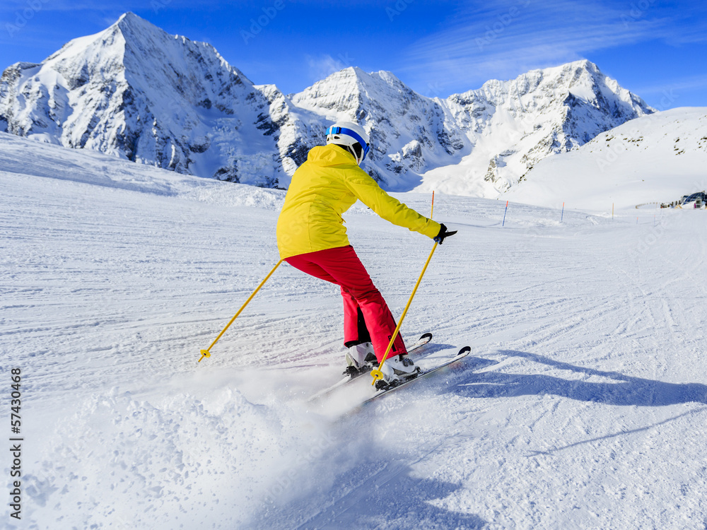 Ski, skier on ski run - woman skiing downhill Ski, skier on ski run - woman skiing downhill
