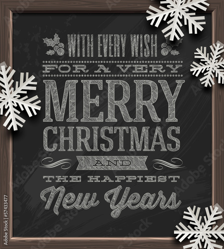 Christmas greetings on a chalkboard and paper snowflakes