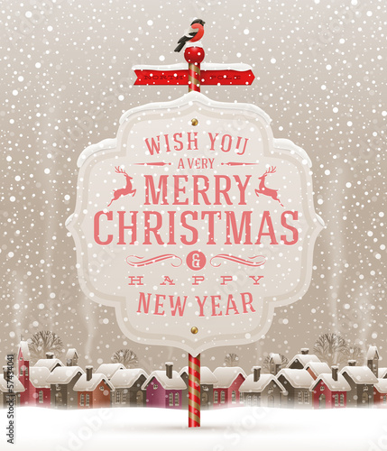 Signboard with Christmas greeting and landscape with village