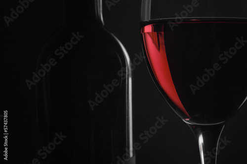 bottle with red wine and glass