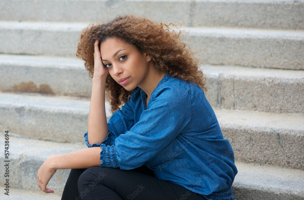 Beautiful young woman sitting on stairs outdoors Beautiful young woman sitting on stairs outdoors