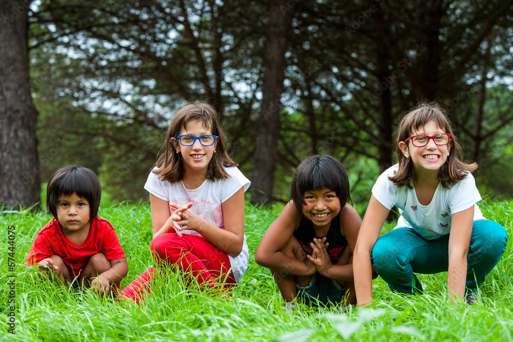 Cute girls sitting in green grass field. Cute girls sitting in green grass field.