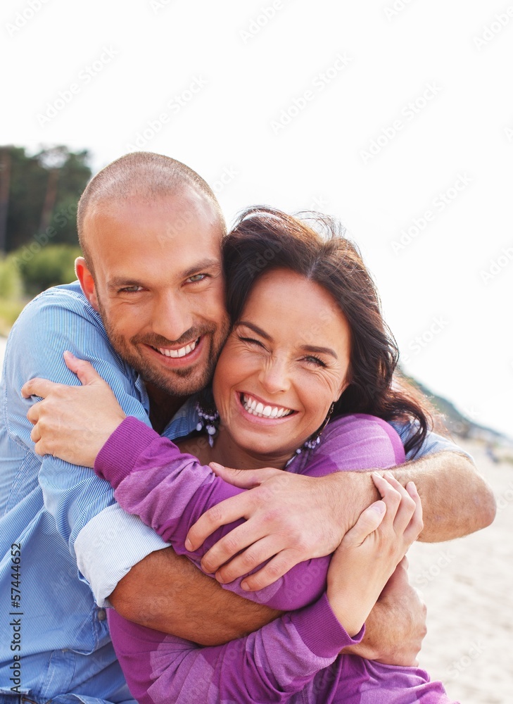 Fototapeta premium Happy smiling middle-aged couple on a beach