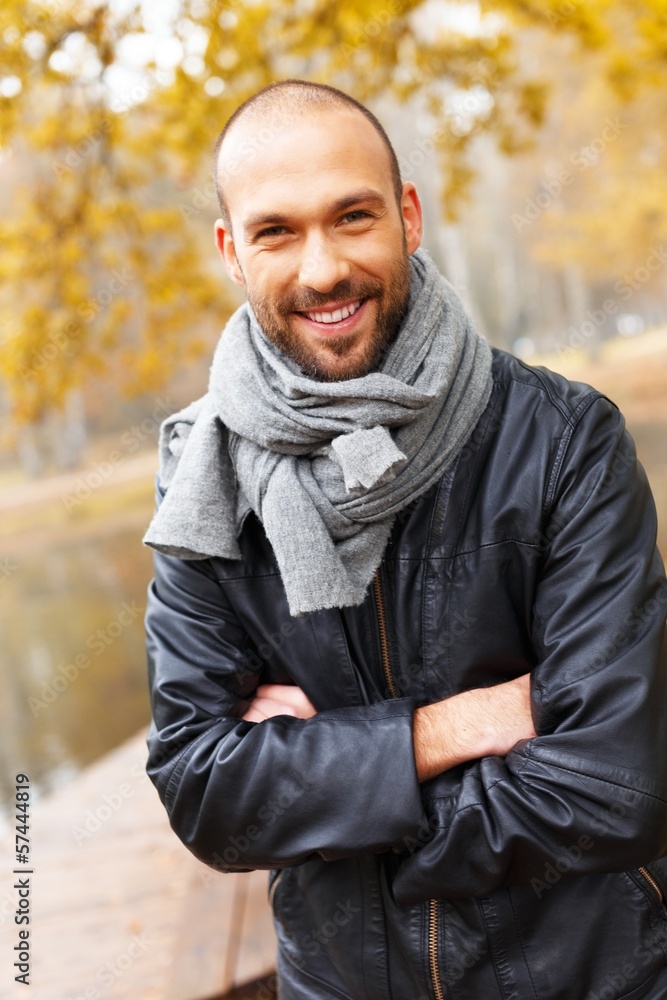 Positive middle-aged man alone outdoors 
