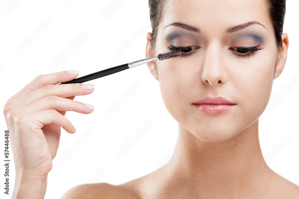 Woman putting on make up with cosmetic brush