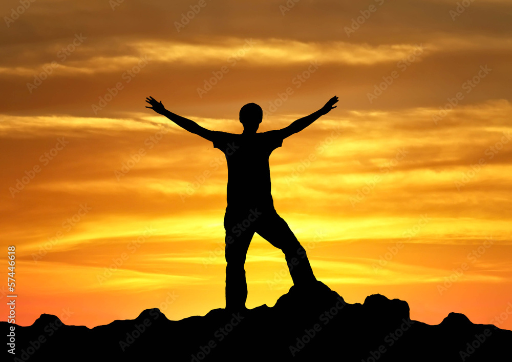 Silhouette of a winner on the mountain top