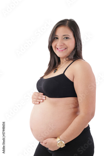 Young pregnant woman smiling at camera against white background