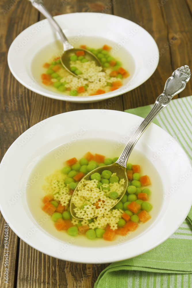 Soup with star shaped noodles, carrots and green peas Soup with star shaped noodles, carrots and green peas