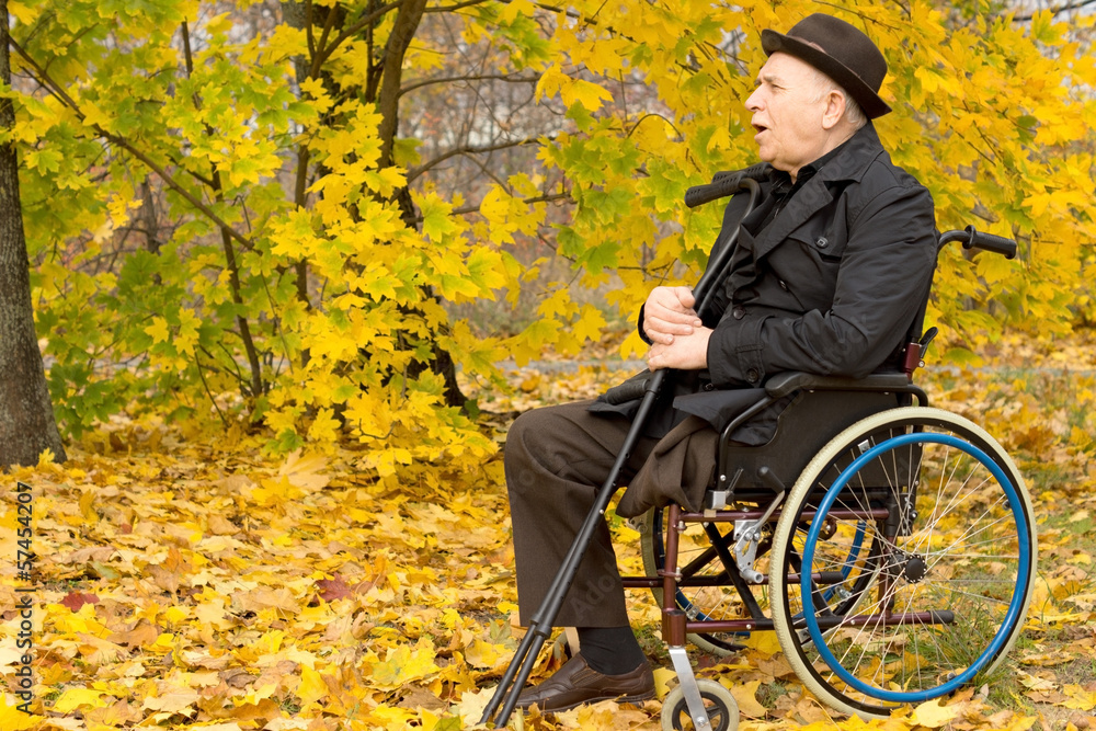 Retired handicapped man in an autumn park Retired handicapped man in an autumn park